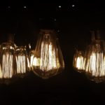 Articles - Vintage bulbs hanging against a dark background